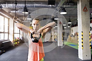 Beautiful sport woman performing kettlebell swing, holding kettlebell in hands. Routine workout for woman& x27;s physical