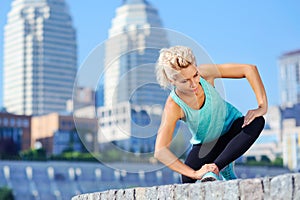 Beautiful sportive woman standing on knee