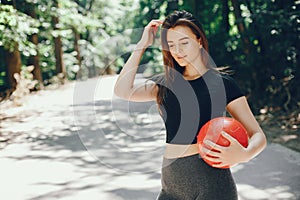 Beautiful  sports girl in a summer sunny park