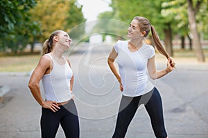 Beautiful, sports girls exercising on a park background. Fitness lifestyle concept. Copy space.