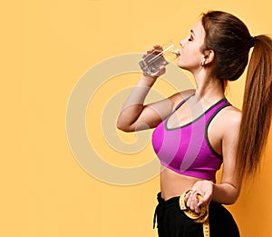 Beautiful sports woman hold tape measure and drink water weight loss life concept