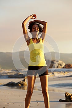 Beautiful sports woman laughing after workout