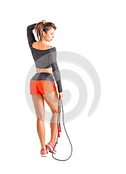 Beautiful sportsgirl with skipping rope isolated on white. Healthy life concept.