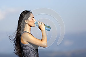 A beautiful sporty caucasian girl drinking water