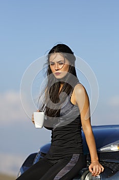 A beautiful sporty caucasian girl drinking water