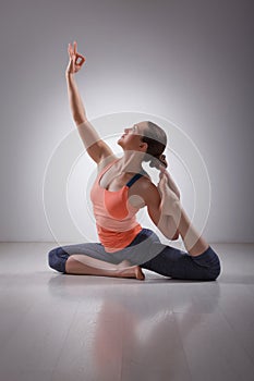 Beautiful sporty fit yogi girl practices yoga