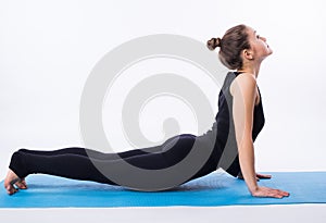 Beautiful sporty fit yogini woman practices yoga asana adhomukha svanasana - downward facing dog pose isolated on white