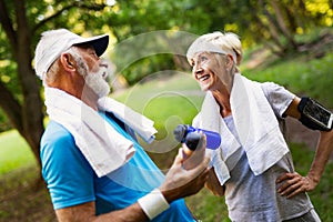 Beautiful sporty mature couple styaing fit with sport