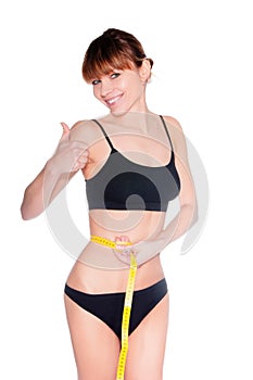 Beautiful sporty woman body with yellow measure on white background