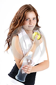 Beautiful sporty woman drinking watter and eating apple photo