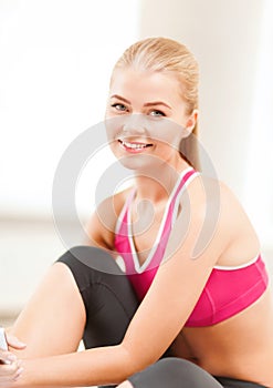 Beautiful sporty woman having break in gym