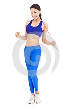 Beautiful sporty woman holding red tape