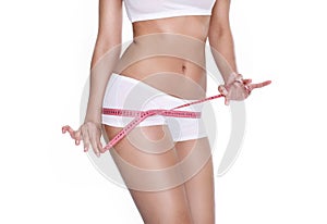 Beautiful sporty woman with measure tape around body