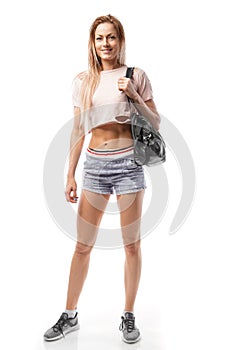 Beautiful sporty woman with sports bag goes to training, isolated on white