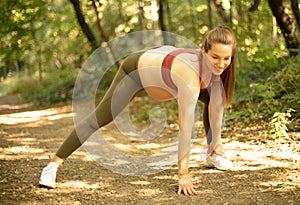 Beautiful sporty woman stretching warming up before working out