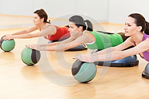 Beautiful sporty women doing exercise on ball.