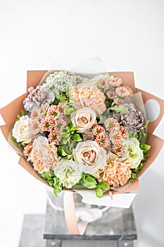 Beautiful spring bouquet. flowers arrangement with various of colors in glass vase on old table. bright room