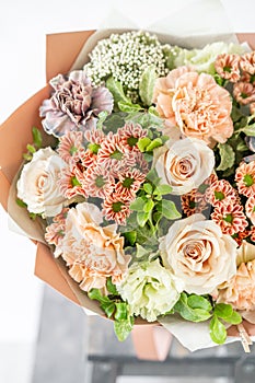 Beautiful spring bouquet. flowers arrangement with various of colors in glass vase on old table. bright room