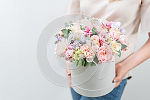 Beautiful spring bouquet in round box. Arrangement with various flowers. The concept of a flower shop. A set of photos