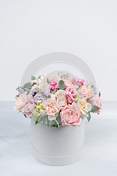 Beautiful spring bouquet in round box. Arrangement with various flowers. The concept of a flower shop. A set of photos