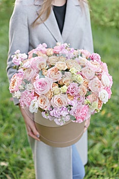 Beautiful spring bouquet in round box. Arrangement with various flowers. The concept of a flower shop. A set of photos