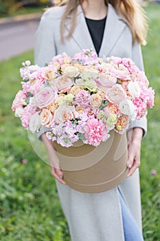 Beautiful spring bouquet in round box. Arrangement with various flowers. The concept of a flower shop. A set of photos