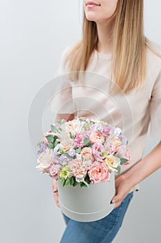 Beautiful spring bouquet in round box. Arrangement with various flowers. The concept of a flower shop. A set of photos