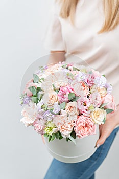 Beautiful spring bouquet in round box. Arrangement with various flowers. The concept of a flower shop. A set of photos