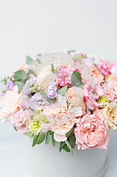Beautiful spring bouquet in round box. Arrangement with various flowers. The concept of a flower shop. A set of photos