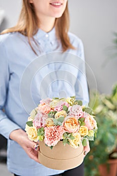 Beautiful spring bouquet in round box. Arrangement with various flowers. The concept of a flower shop. A set of photos