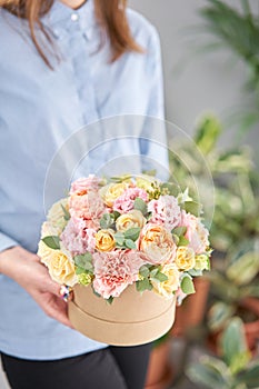 Beautiful spring bouquet in round box. Arrangement with various flowers. The concept of a flower shop. A set of photos