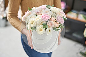 Beautiful spring bouquet in round box. Arrangement with various flowers. The concept of a flower shop. A set of photos