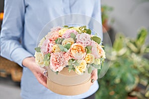 Beautiful spring bouquet in round box. Arrangement with various flowers. The concept of a flower shop. A set of photos