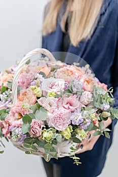 Beautiful spring bouquet in wicker basket. Arrangement with various flowers. The concept of a flower shop. A set of