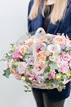 Beautiful spring bouquet in wicker basket. Arrangement with various flowers. The concept of a flower shop. A set of