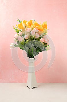 Beautiful spring floral arrangement.Empty podium for product with fresh flowers of daffodils and primroses,elegant beauty concept.