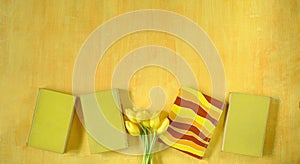 beautiful spring flowers, yellow tulips flowers with books on yellow background, concept, flat lay, negative space,free copy space