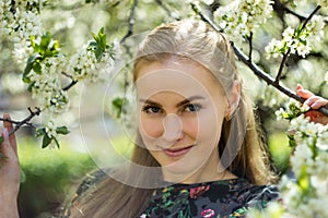 Beautiful spring girl in blooming tree