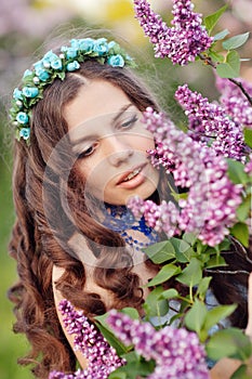 Beautiful spring girl in lilac flowers