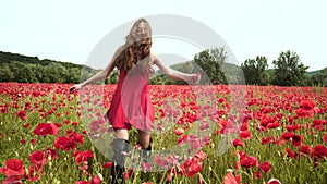 Beautiful spring girl run in poppy field. Beauty young woman on poppies background, spring blossom flowering meadow