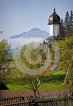 Beautiful spring landscape with church and mountain.