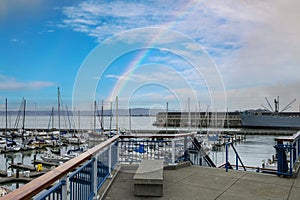 a beautiful spring landscape at Fisherman\'s Wharf on Pier 39 with boats and yachts docked in the harbor with ocean water