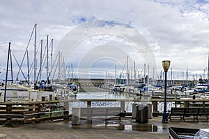 a beautiful spring landscape at Fisherman's Wharf on Pier 39 with boats and yachts docked in the harbor with ocean water