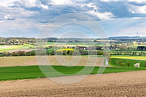 Beautiful spring landscape with green meadows, the sky with picturesque clouds