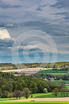 Beautiful spring landscape with green meadows, the sky with picturesque clouds