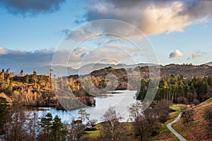 Beautiful Spring landscape image in Lake District looking towards Langdale Pikes during colorful sunset