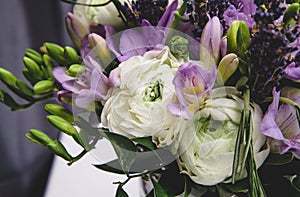 Beautiful spring wedding flowers white, violet, green buttercup ranunculus, fresia, lavender. Background soft macro