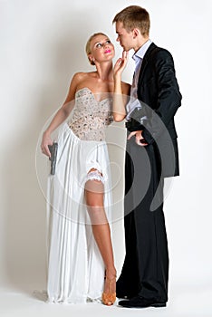 Beautiful spy couple in evening dress with a guns.