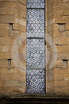 Beautiful stained-glass window of old building. Exterior of gothic style architecture.