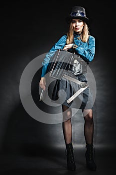 Beautiful steampunk woman with bag on black.